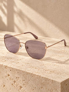 Elodie Slim Butterfly Sunglasses — warm neutral editorial setting
