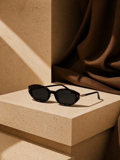 Sable sunglasses on a warm stone pedestal