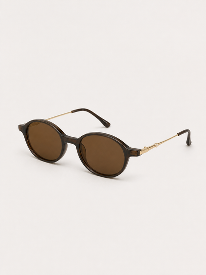Sienna brown oval sunglasses shown from a three-quarter studio angle
